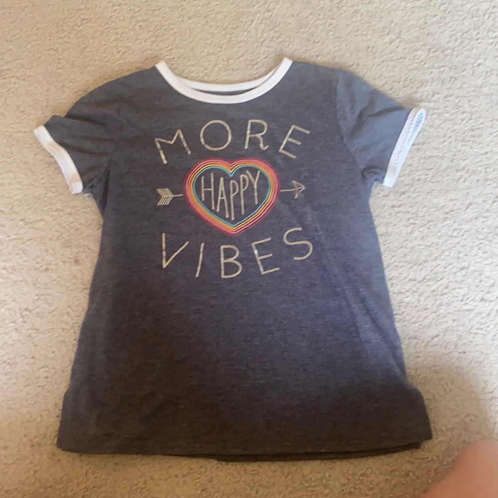 grey t shirt says “more happy vibes” with rainbow